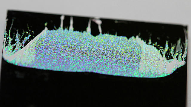A layer of tiny grains can slow sound waves